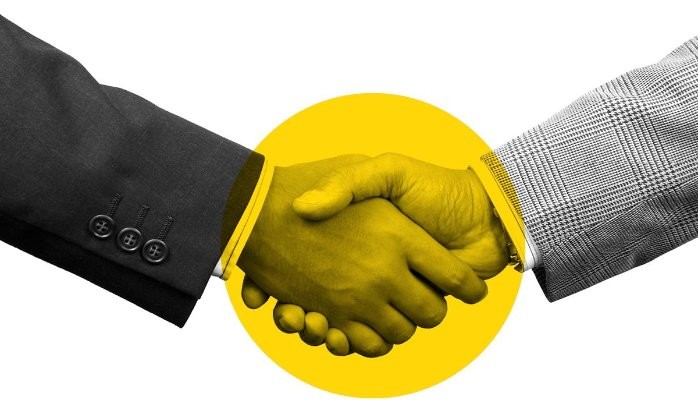 handshake with suit jackets and a yellow circle for design 